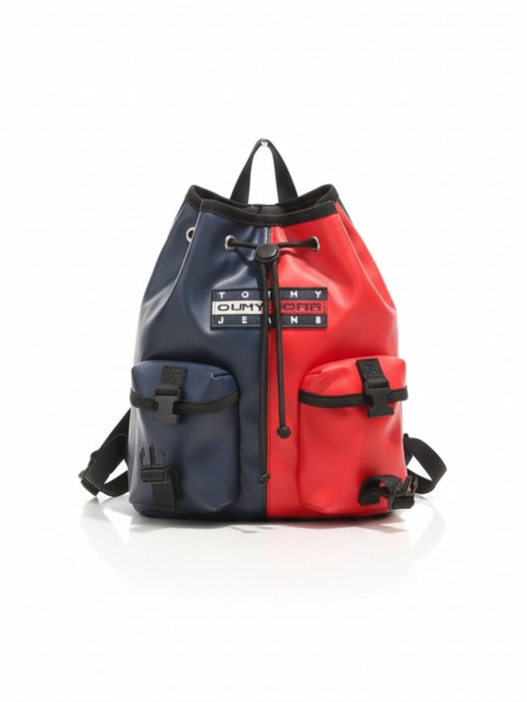 תיק גב דו-צבעי כחול ואדום של טומי הילפיגר עם סגירת שרוך, שתי כיסים קדמיים ורצועות מתכווננות בגב.