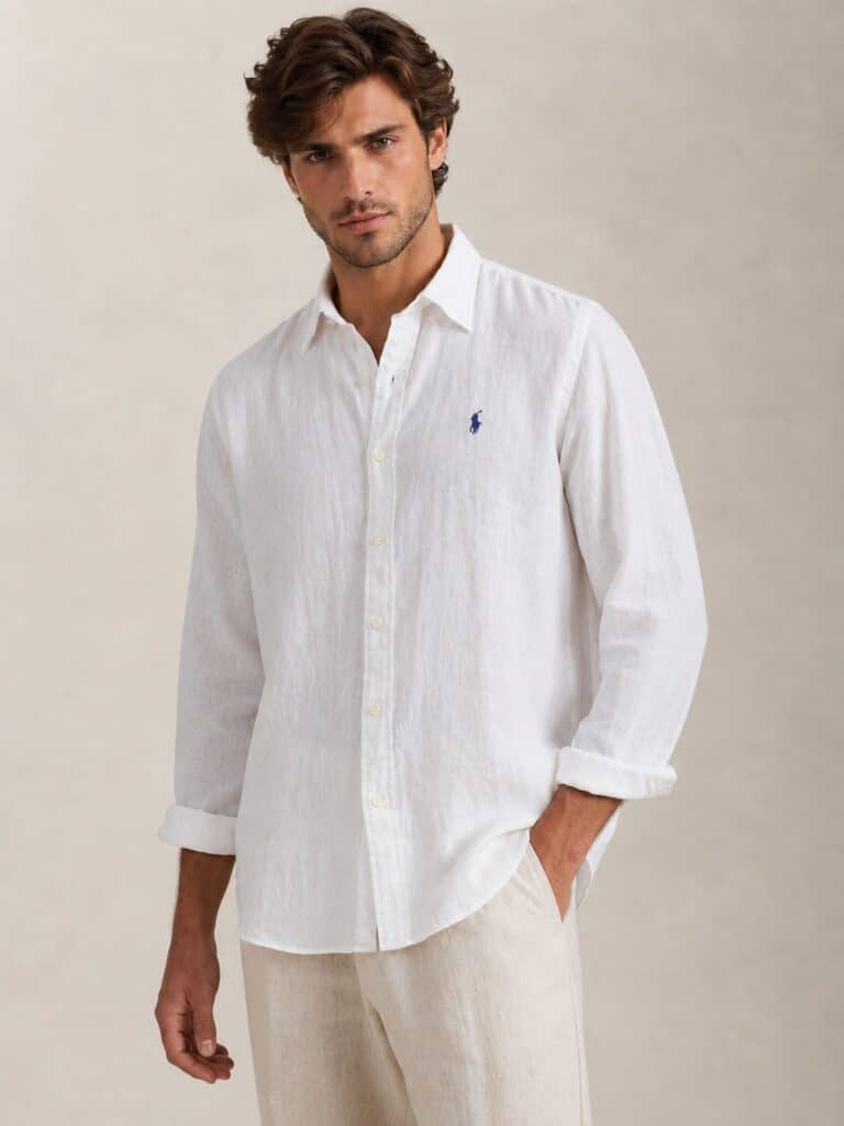 חולצת פשתן לבנה מכופתרת מבית פולו ראלף לורן (Polo Ralph Lauren), בד קליל למראה קיצי ומרענן בחופשה.
