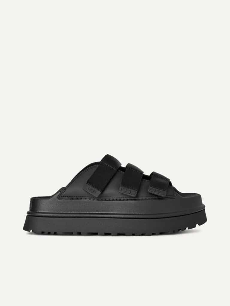כפכפי פלטפורמה UGG לנשים דגם GoldenGlow Slide בצבע שחור עם שלוש רצועות מתכווננות וסוליה קפיצית.